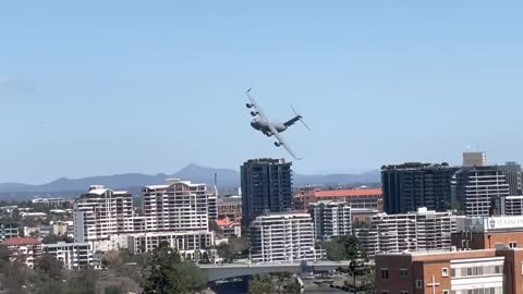 Pilot Flies Between Buildings