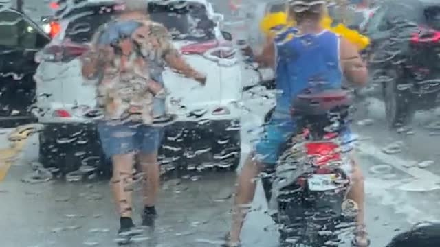 Older Lady Gives Motorcyclist Rain Coat During Storm