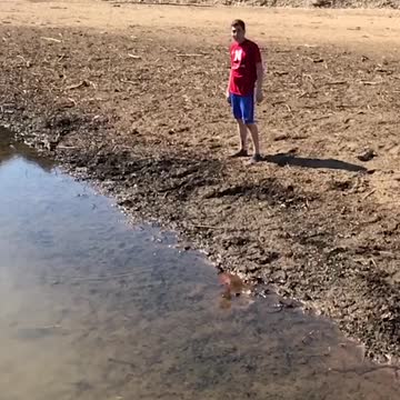 Heroic Hiker Leaps Across River, But Loses His Shoes In The Mud