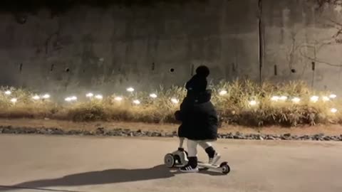 Baby riding a kickboard