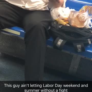 Man eats hot dog with sandwich bread