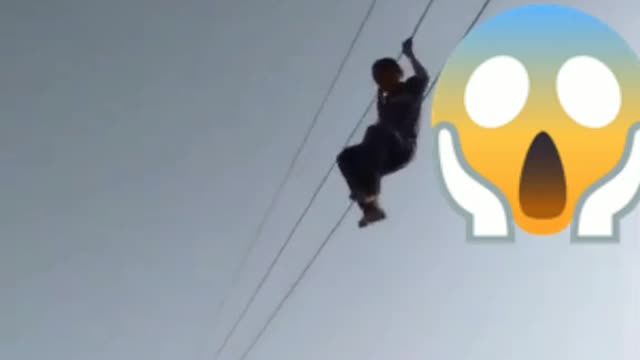 People Hanging on high voltage cables