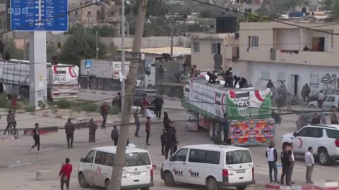 Chaotic scenes as people run after lorries carrying aid in Gaza