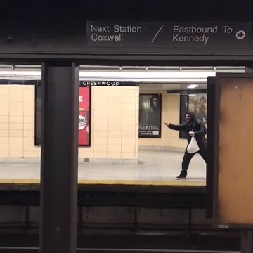 Man with hoodie pretend to pull in train