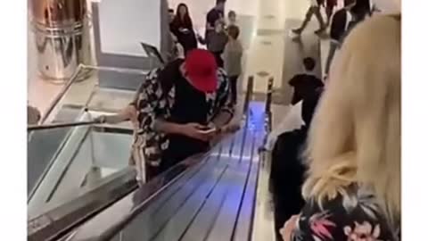 A girl on the escalator takes a man's cell phone 🤣😂😜
