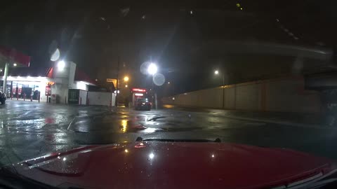 Red Light Runner Nearly Causes Accident on Wet Roads