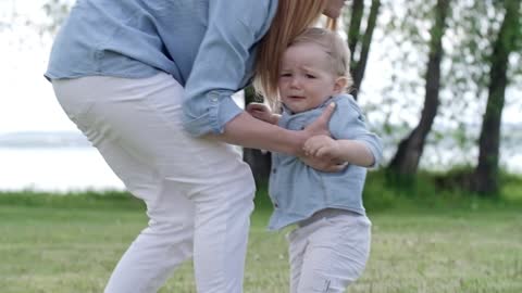 Training the child to walk.