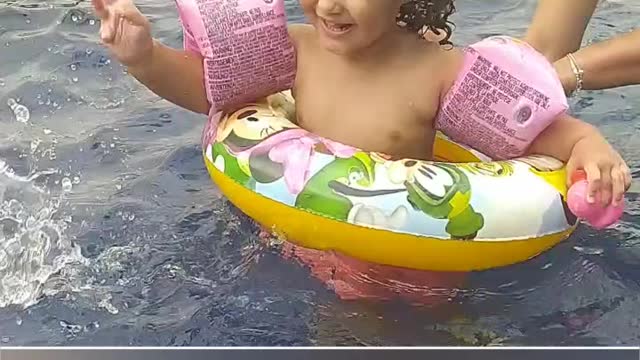 A baby's first pool bath