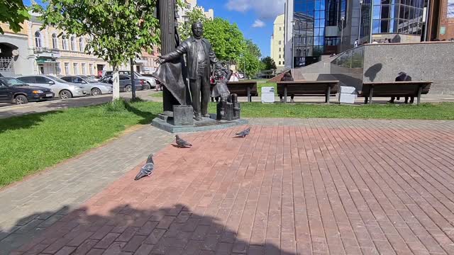 Public space of the city: benches, fountain, birds, sculpture