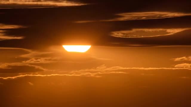 The beautiful sunset against the cloud stream.