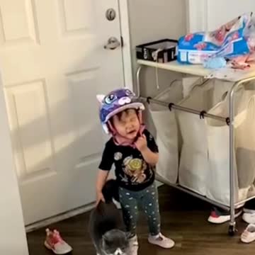Cat taking care of crying baby