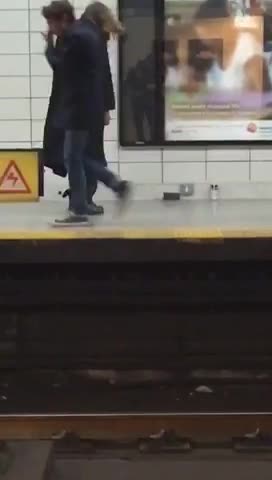 Black trenchcoat guy tap dances in subway
