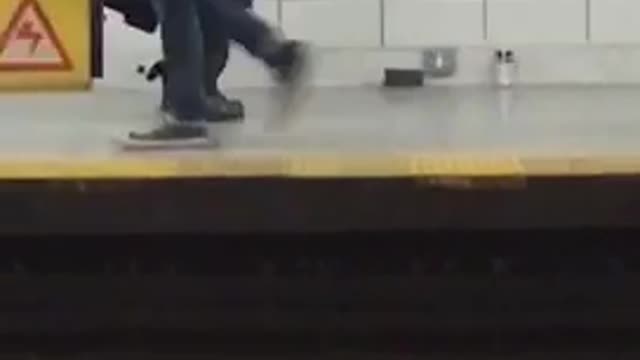 Black trenchcoat guy tap dances in subway