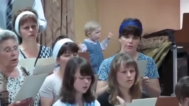 little girl conducts a choir