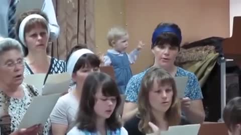 little girl conducts a choir