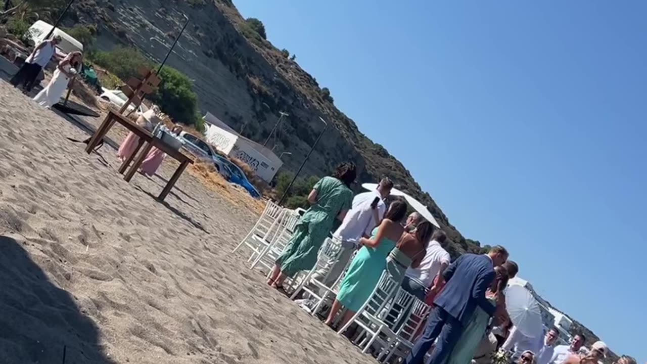 Woman falls asleep at the beach and wakes up next to a wedding 😂