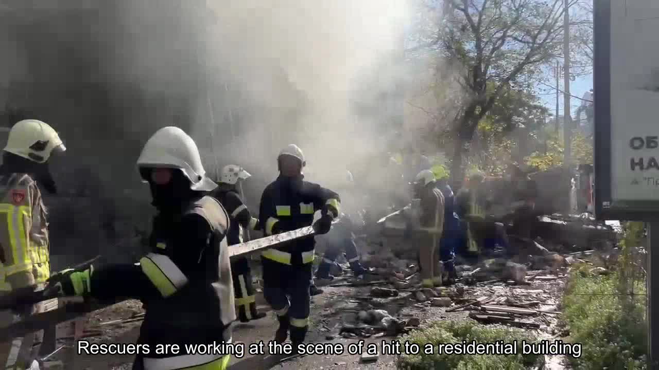Rescuers work at the site of a hit to a residential building in Kyiv.