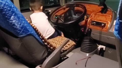 Baby learns to drive a car