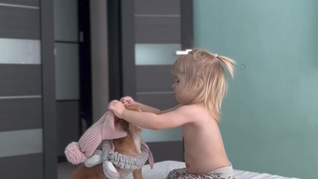 A little lady takes care of her puppy.