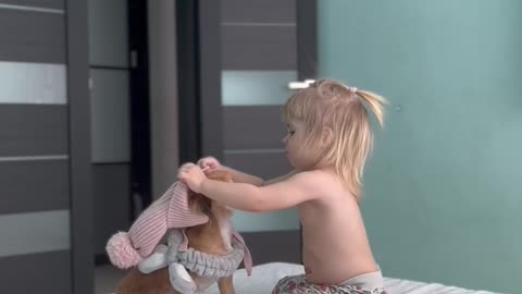 A little lady takes care of her puppy.