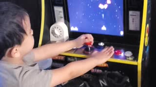 Little Tim playing Galaga