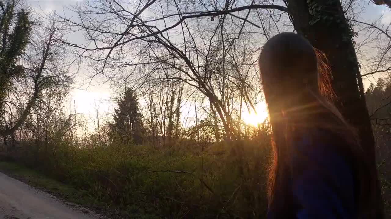 A Walking Woman Enjoying The View Of The Sunset