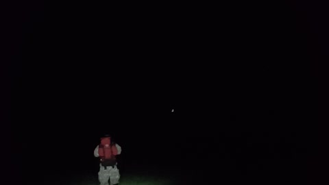 Walking away from the camera shot. Night time hiking Dartmoor.