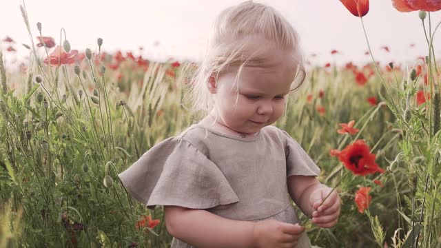 Baby discovering the smell of the flower