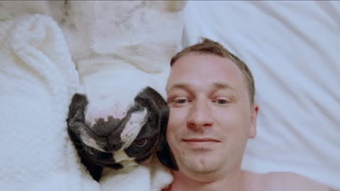 Close up Of a Man with His Dog in Bed