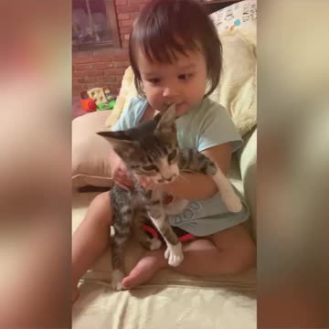 baby girl and her kitten