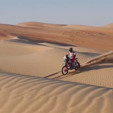Riding a motorbike over sand dunes