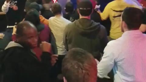 Multiple people screaming at bar and pushing each other