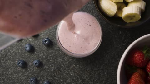 Overhead Pouring Strawberry Smoothie into Glass