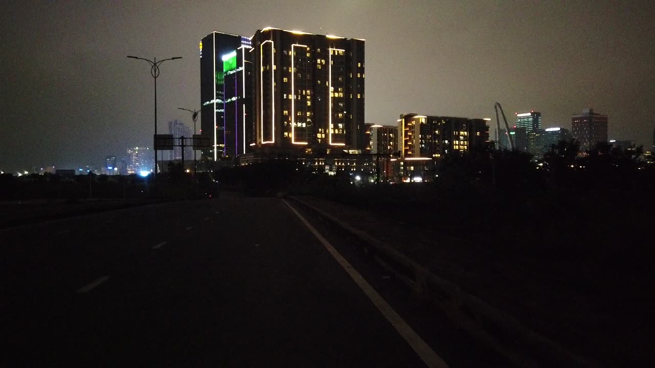 drive Bicycle near Thu Thiem bridge , in the evening