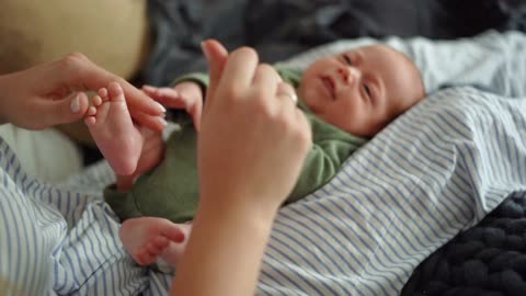 A Mother Massaging Her Baby's Feet