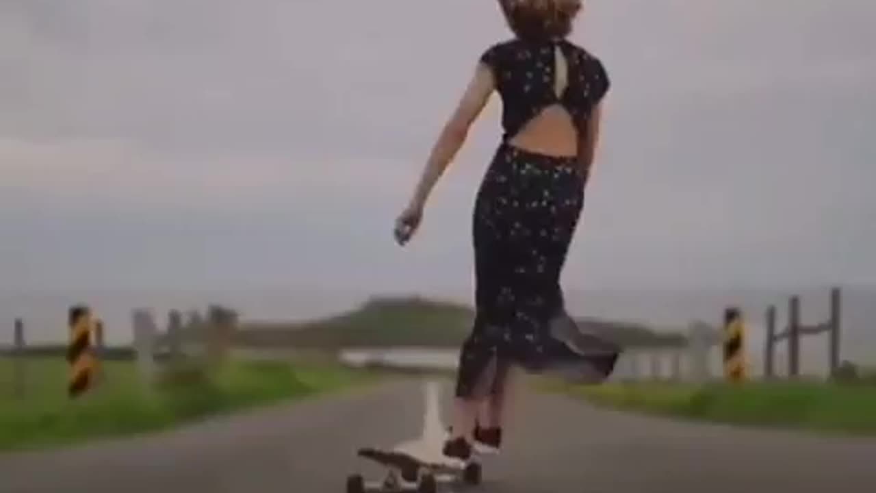 chick dances while she carves on her long board.