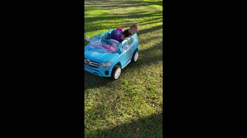 Toddler driving a car for the first time