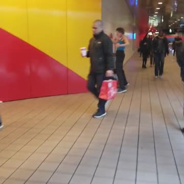 Guy black pants blue tank top punching fighting wall