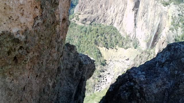 Basaseachi Falls seen through openings in the rock formations