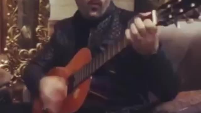 Guy playing guitar and singing Ebi's song