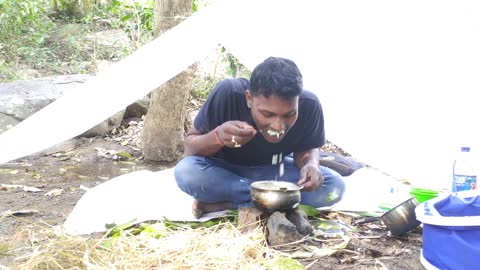 Eating simple indian food in forest.