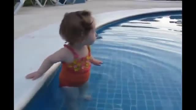 Funny baby try to get into the swimming pool