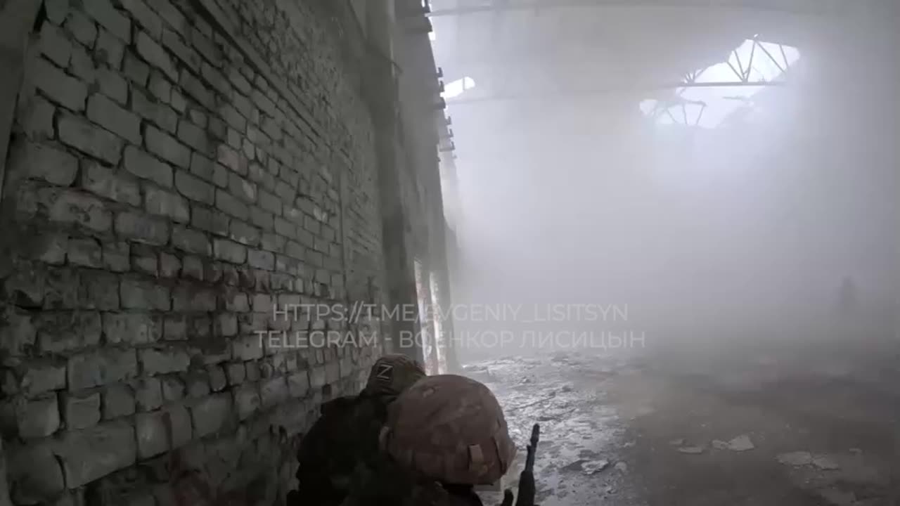 Footage of Russian soldiers evacuating a wounded enemy on the battlefield.