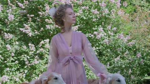 a-woman-standing-beside-pet-dogs