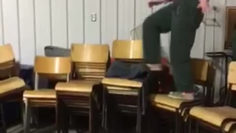 Girl in santa costumer walks across chairs falls on ribs