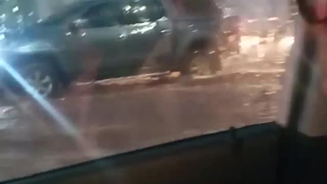 Very Calm Man in His Car in the Middle of a Flash Flood