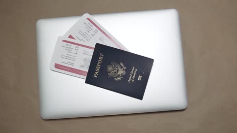 Passport on Top of a Laptop