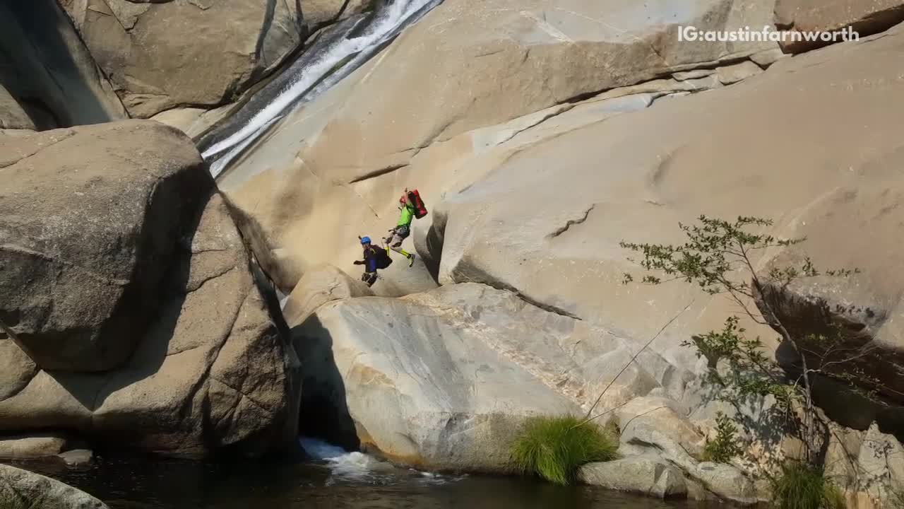 Five guys slide down rock into water