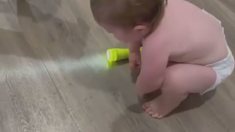 baby having fun playing with her dog.