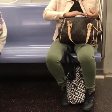 A woman with bag on her lap clips her nails
